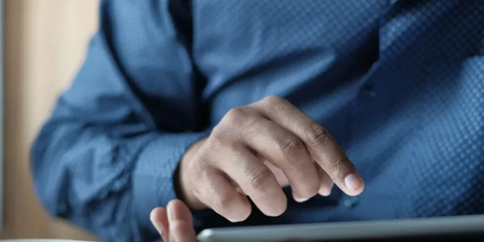 Mains tenant une tablette affichant des évaluations en étoiles et des statistiques d'avis