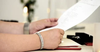 Bureau de notaire en pleine journée avec contrat de mariage et mains anonymes consultant des documents
