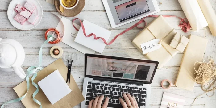 Personne anonyme à un bureau avec ordinateur portable, carnet et moodboard