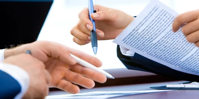 Documents de succession, relevés bancaires et actes de propriété organisés sur un bureau avec une calculatrice